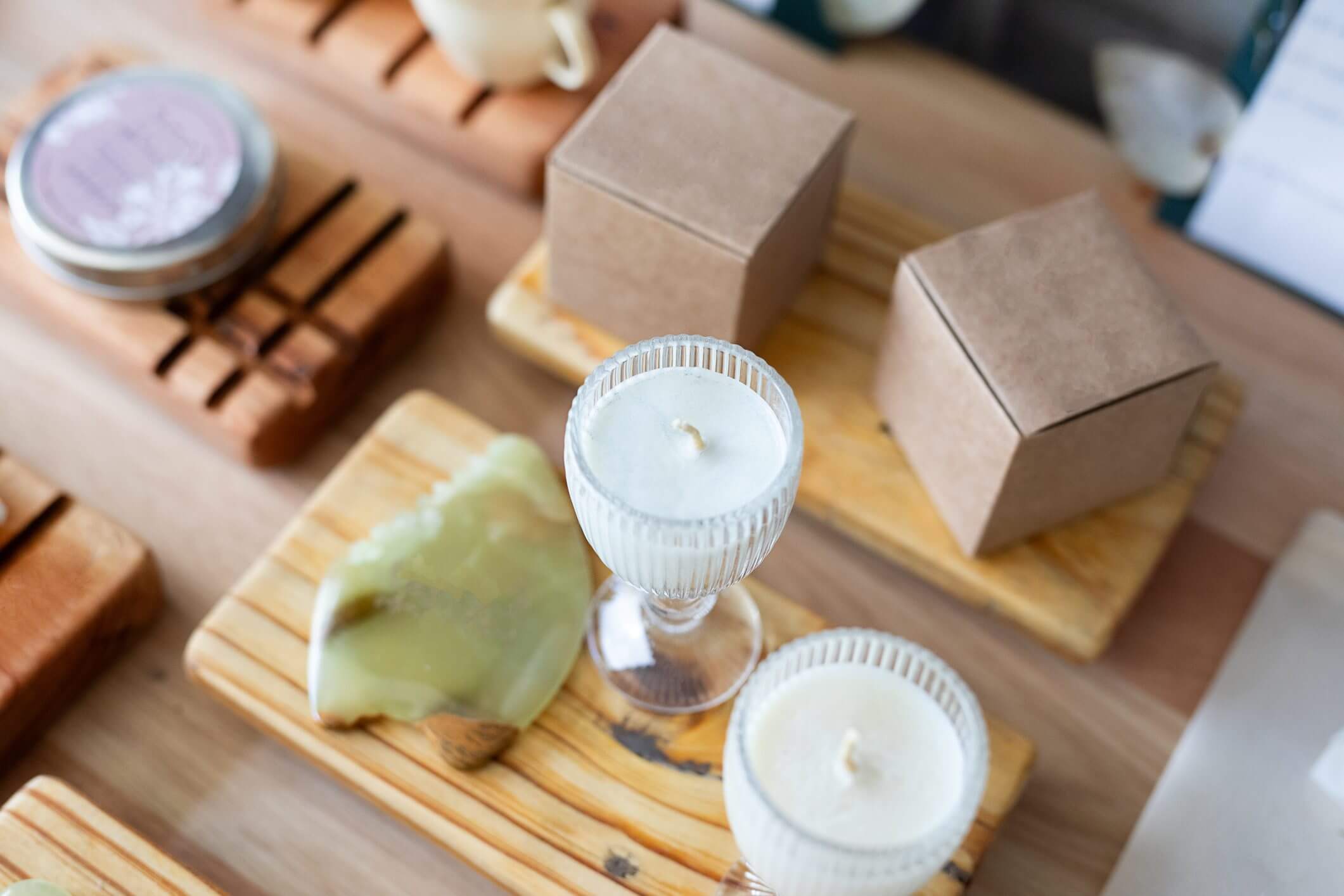 Candles and boxes on wooden trays.