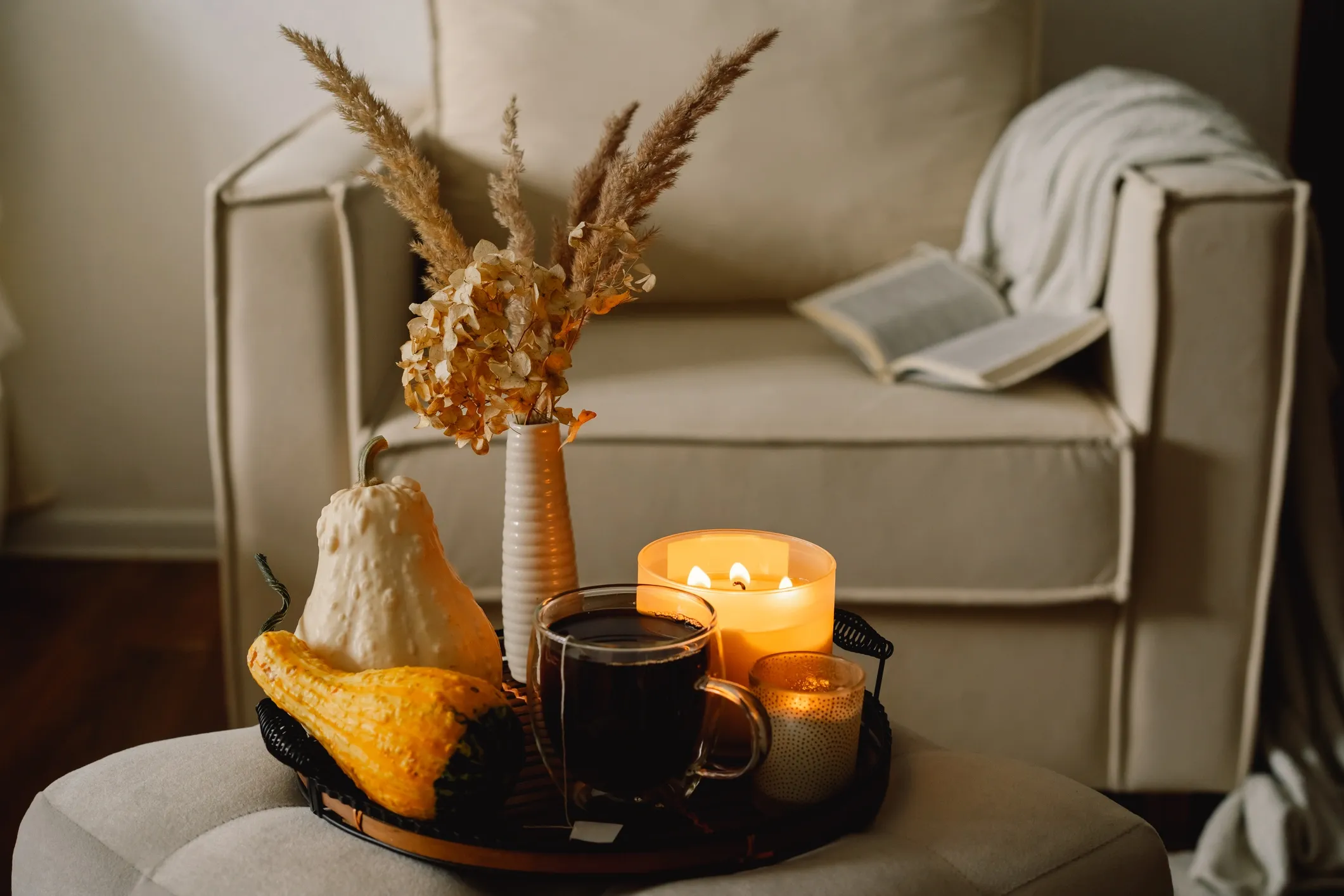 Cozy autumn scene with candles and pumpkins.