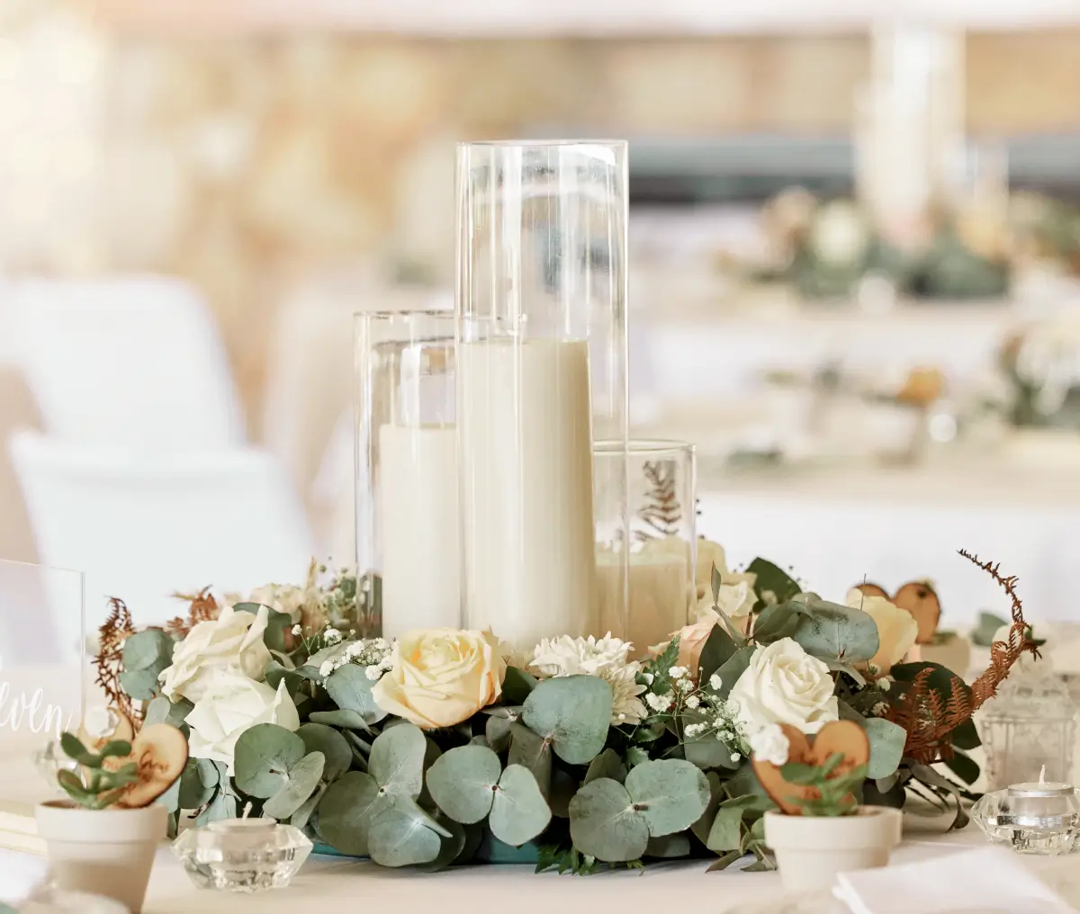 Floral wedding centerpiece with candles and eucalyptus
